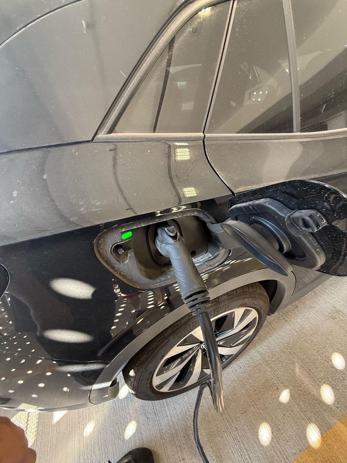 Mobile charging connector plugged into an electric vehicle charge port