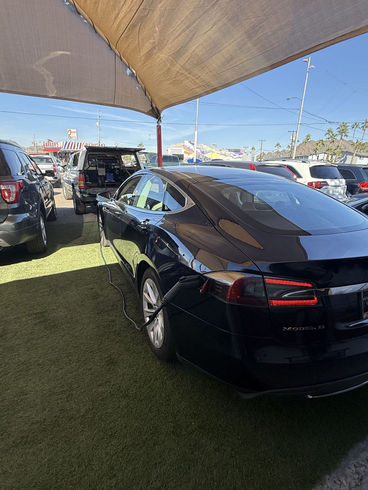 Tesla receiving a mobile charge in a parking lot