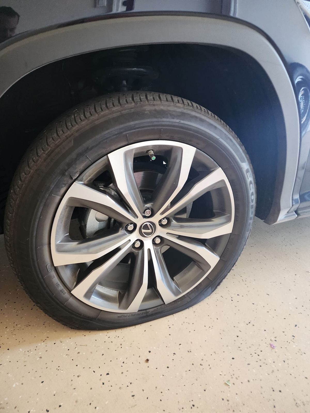 Flat tire on a vehicle in a garage