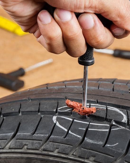 Roadside tire plug being installed in a tread puncture