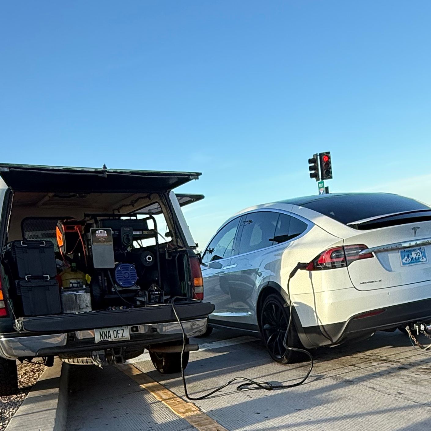 Precision Roadside Service mobile Level 2 unit charging a Tesla on-site